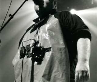 Photo en noir et blanc d'un chanteur habillé comme une sorte de boucher